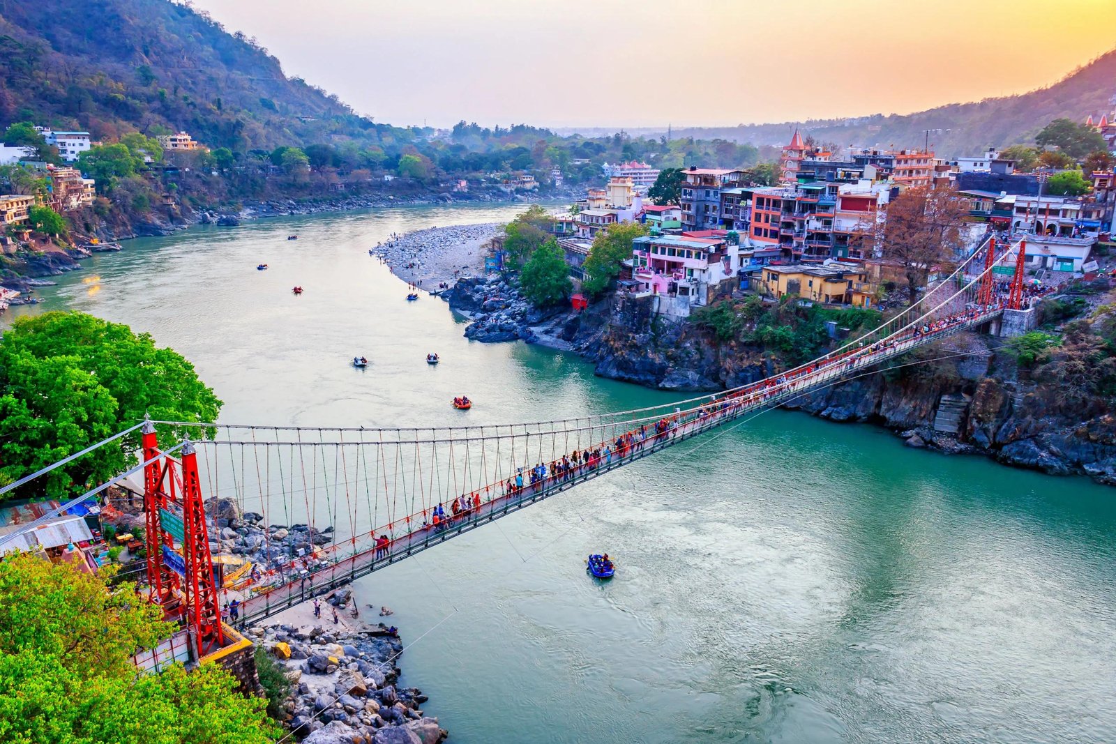 Budget travel itineraries India featuring a suspension bridge over the Ganges River in Rishikesh